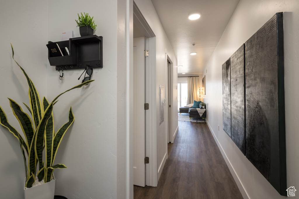 Hallway featuring baseboards and wood finished floors