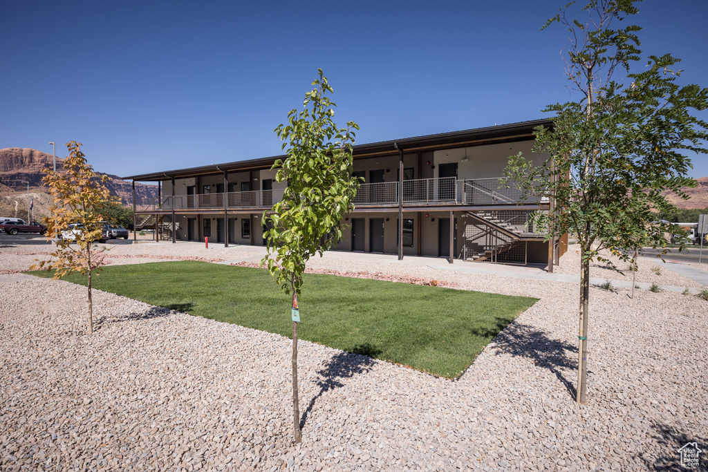 View of building exterior featuring a mountain view and stairs
