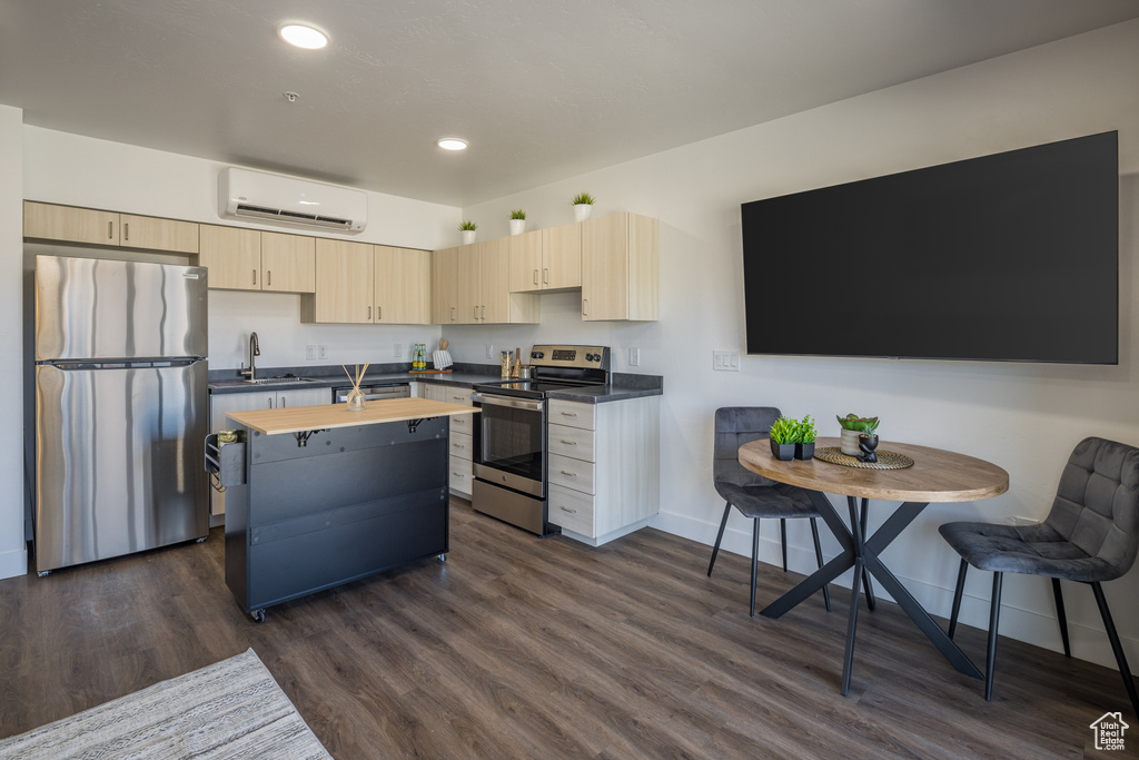 Kitchen featuring a wall mounted AC, dark wood-style flooring, stainless steel appliances, wood counters, and light brown cabinets