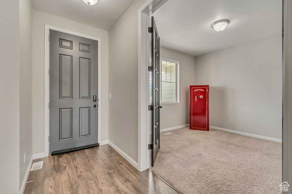 Entryway featuring baseboards and wood finished floors