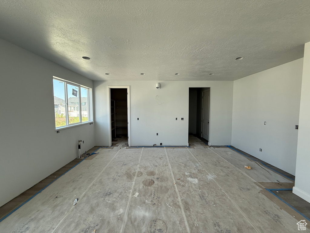 Unfurnished room with a textured ceiling