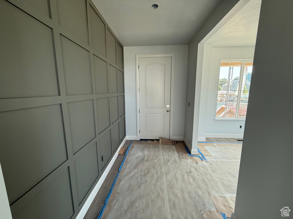 Hall featuring a textured ceiling