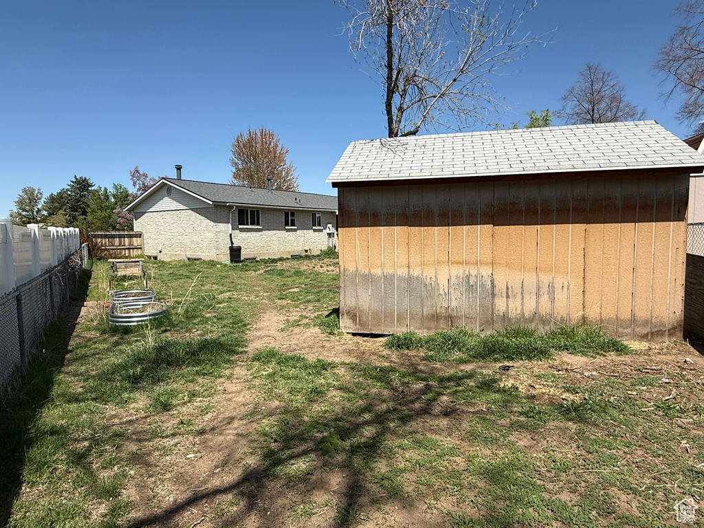 View of shed featuring fence