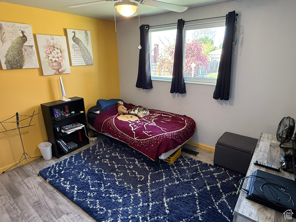 Bedroom with baseboards, a ceiling fan, and wood finished floors