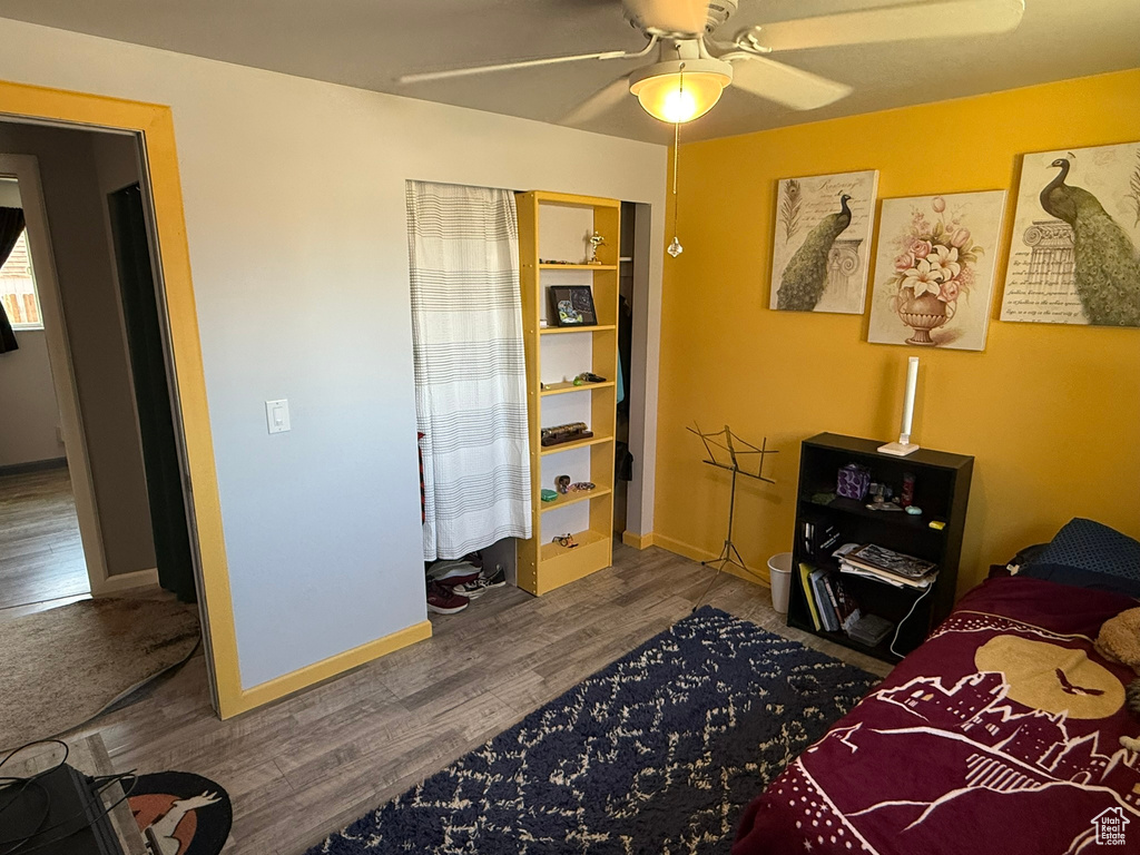 Bedroom with baseboards, a ceiling fan, and wood finished floors