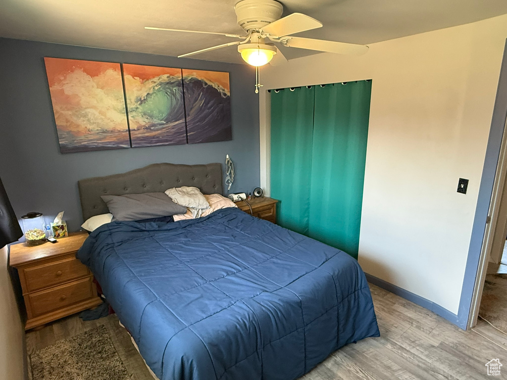 Bedroom with baseboards, a ceiling fan, and wood finished floors