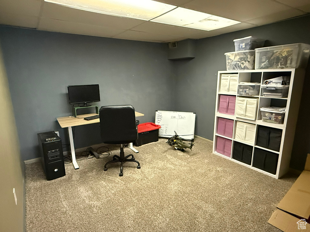 Office area featuring baseboards, carpet flooring, and a paneled ceiling