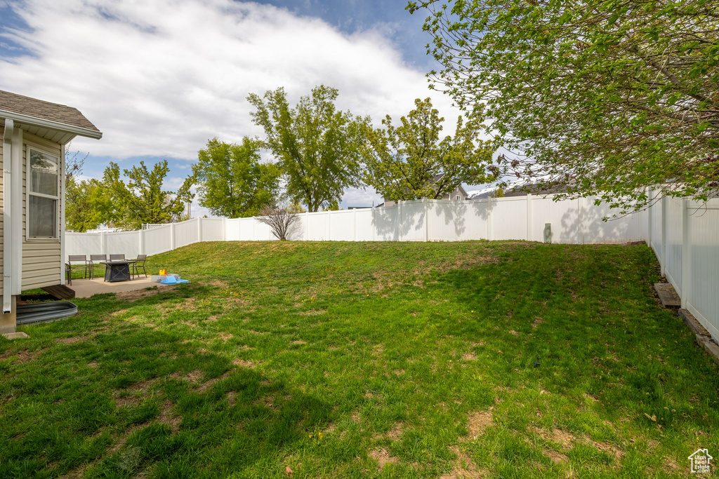 View of yard with a fenced backyard and a patio area