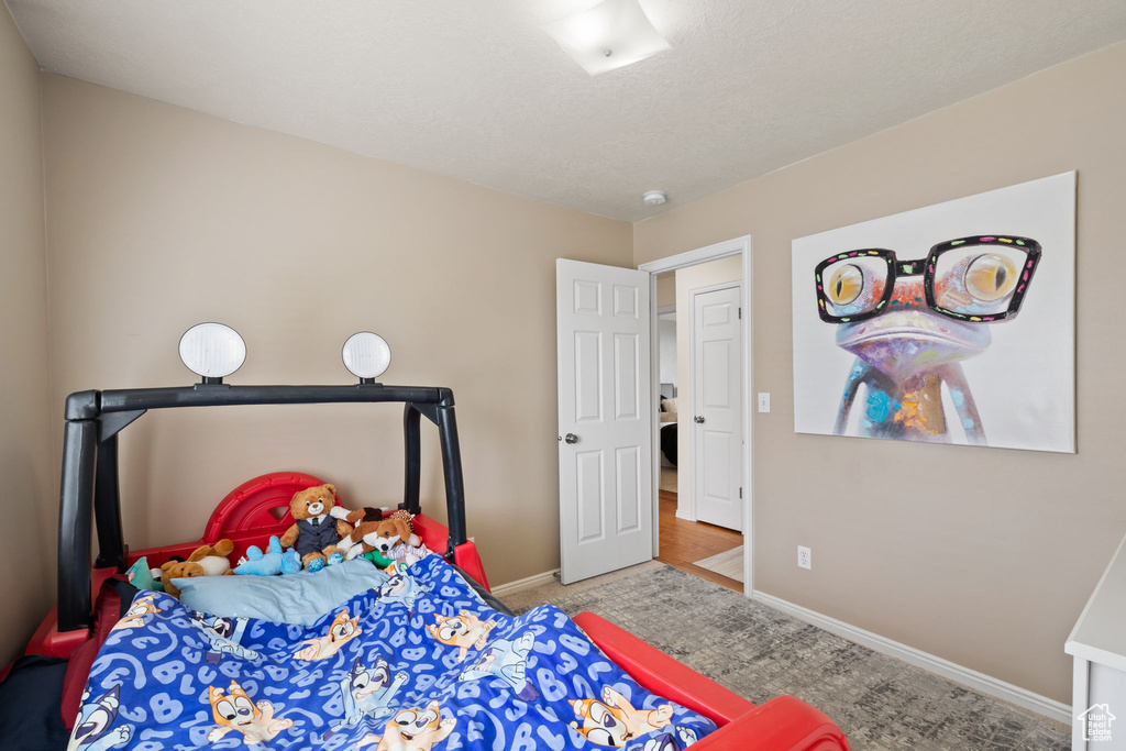 Bedroom featuring baseboards and carpet floors