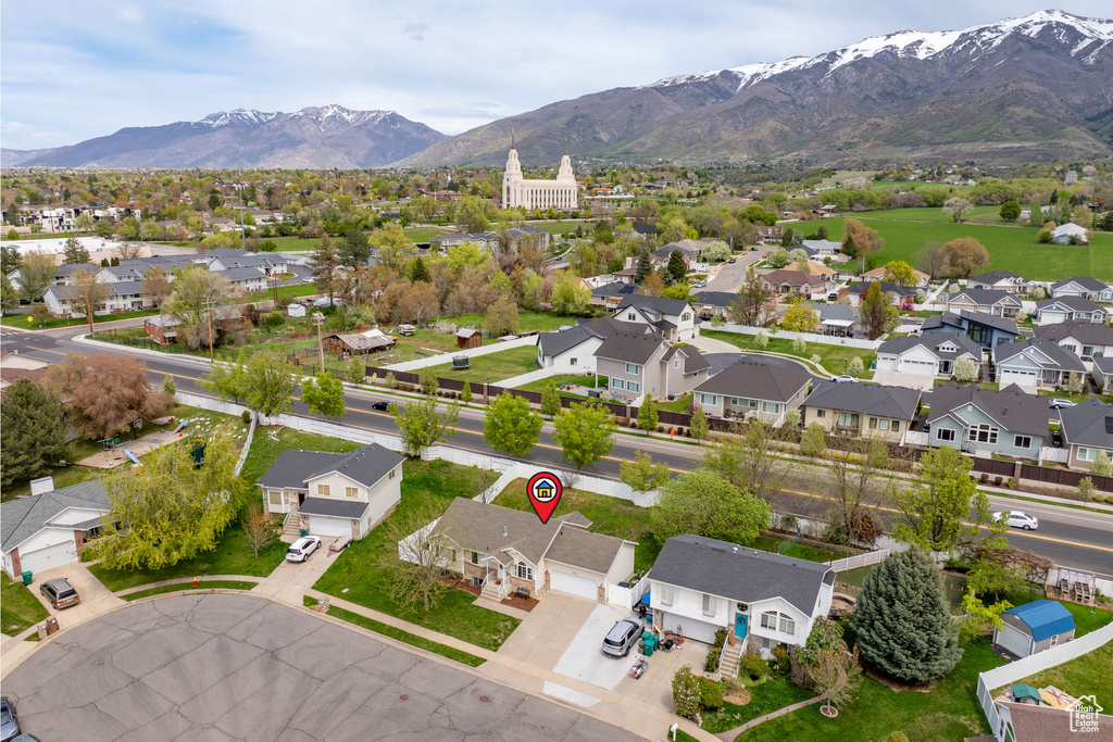 Birds eye view of property with a mountain view and a residential view