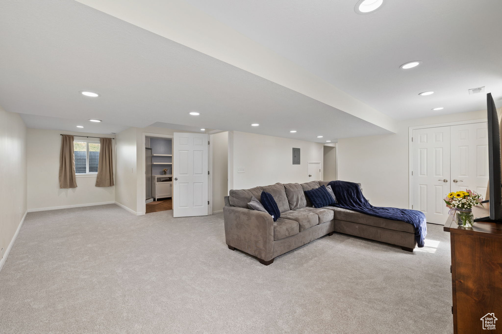 Living room with recessed lighting, baseboards, and light carpet