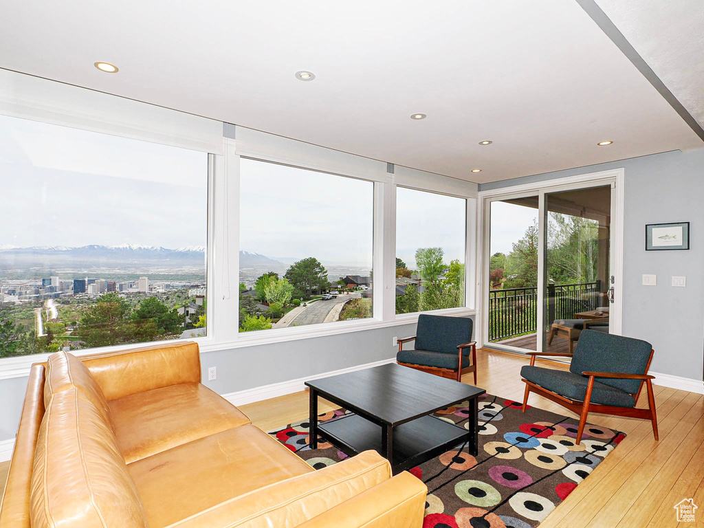 Living area featuring light wood-style floors, baseboards, recessed lighting, and a mountain view