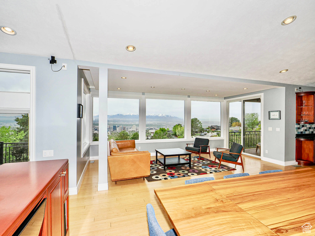 Living area featuring recessed lighting, light wood-style floors, and baseboards