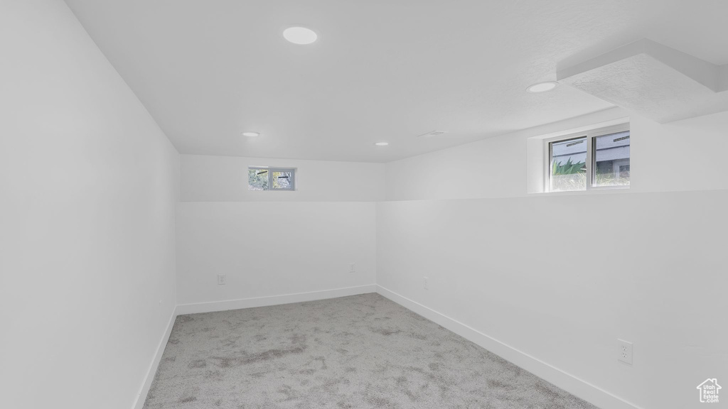 Basement featuring baseboards, recessed lighting, and carpet