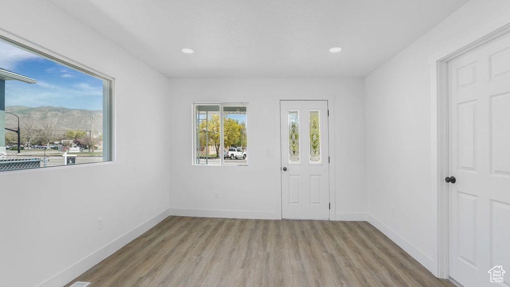 Unfurnished room featuring baseboards, wood finished floors, and recessed lighting