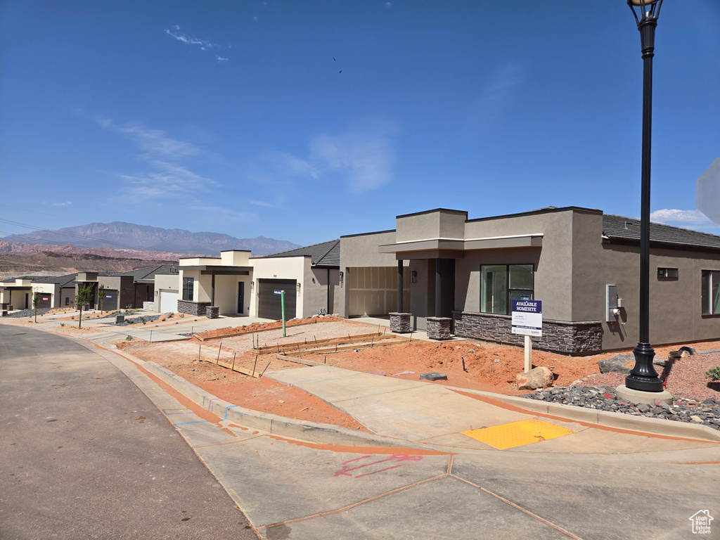 View of front of house featuring stucco siding and a mountain view