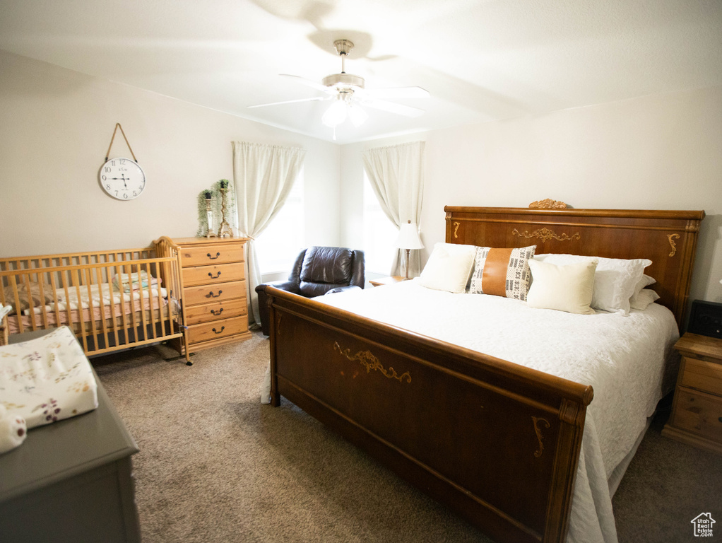 Bedroom with a ceiling fan and light carpet