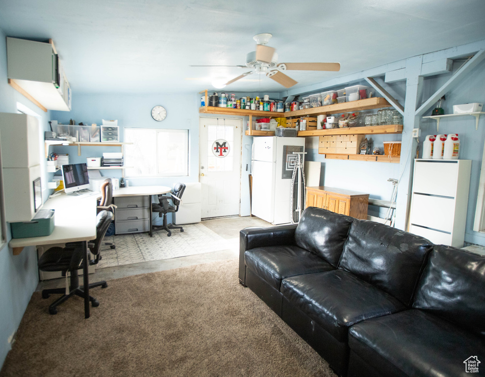 Living room featuring light colored carpet and ceiling fan