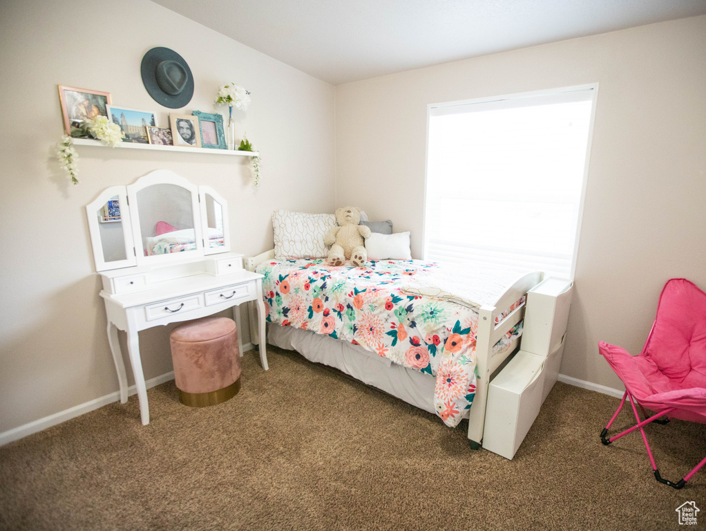 Carpeted bedroom featuring baseboards