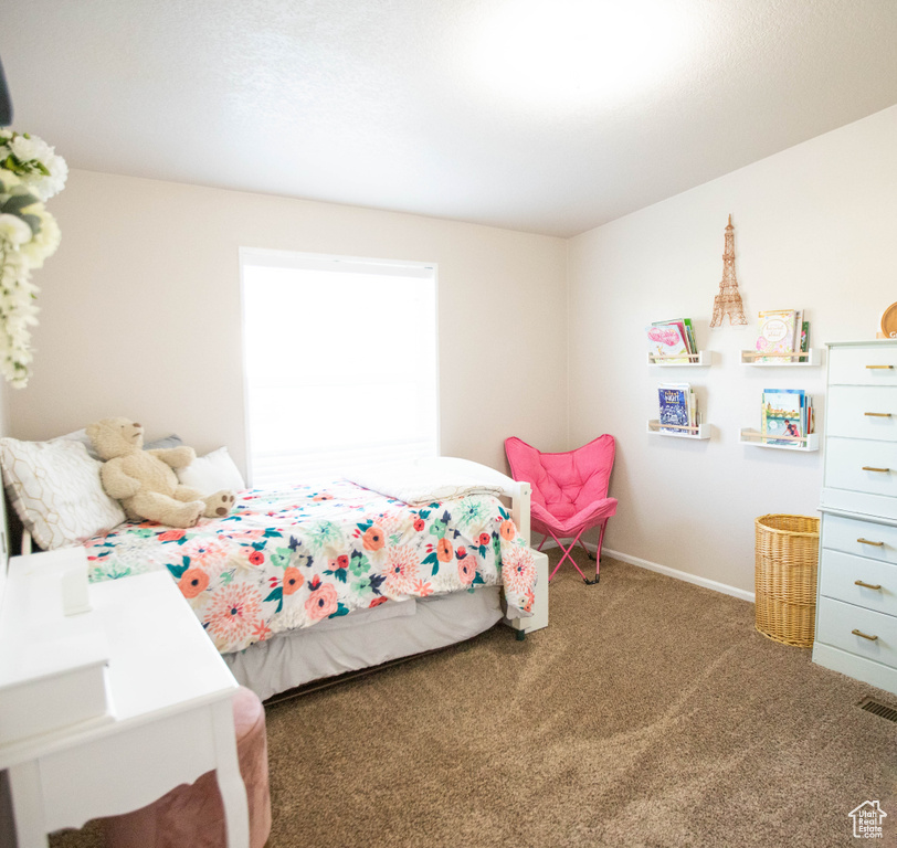 Carpeted bedroom featuring baseboards