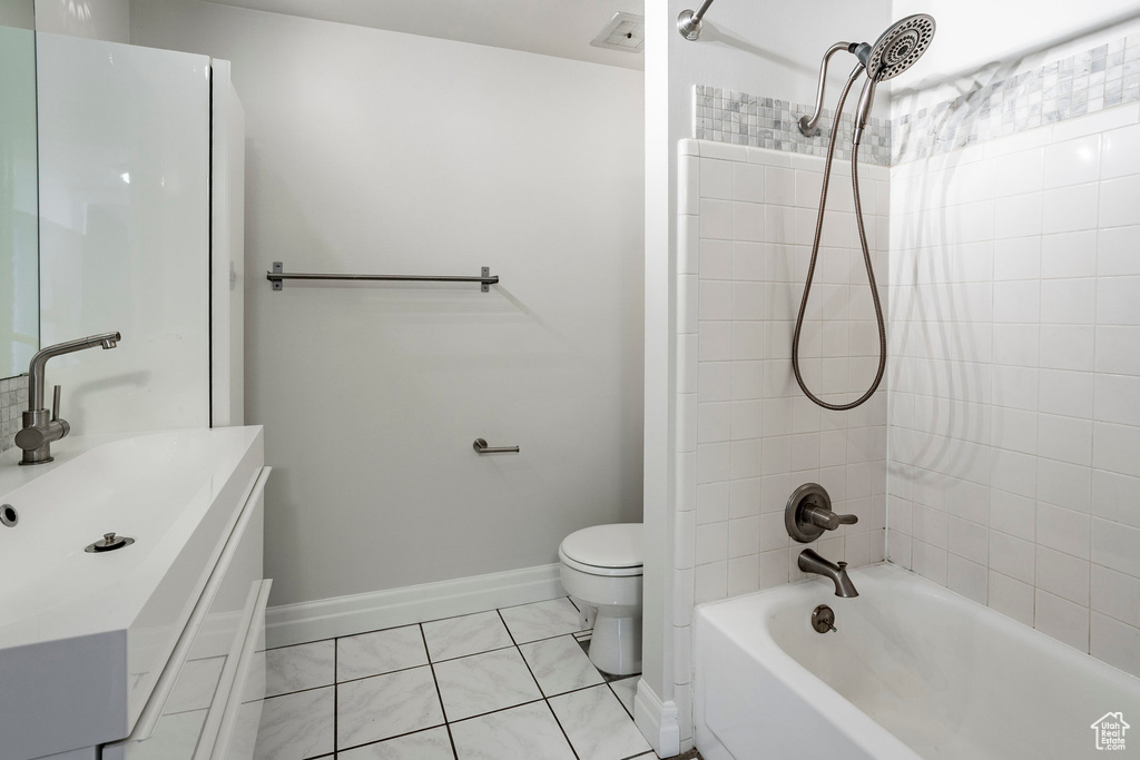 Full bath with bathing tub / shower combination, vanity, and tile patterned flooring