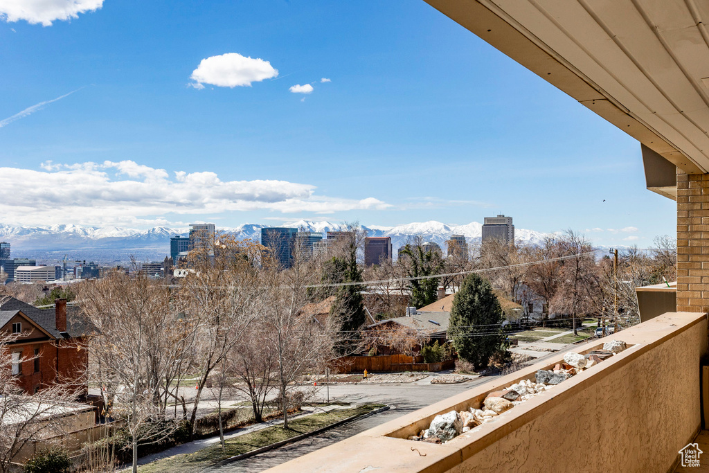 Balcony featuring a mountain view and a view of city