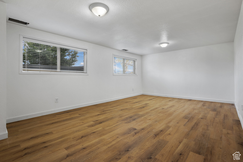 Empty room with baseboards and wood finished floors