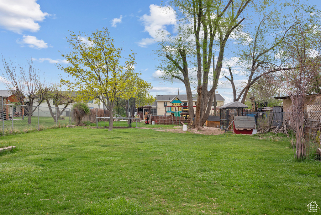 View of yard with fence and a playground