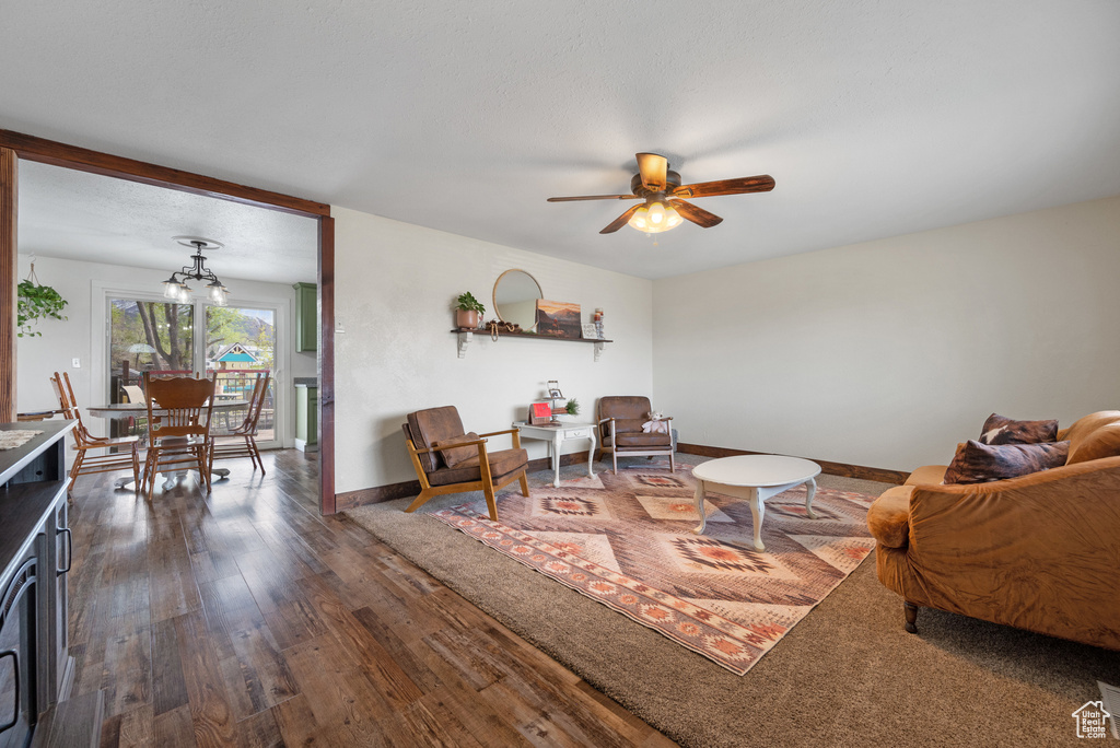 Living room featuring ceiling fan, baseboards, and wood finished floors