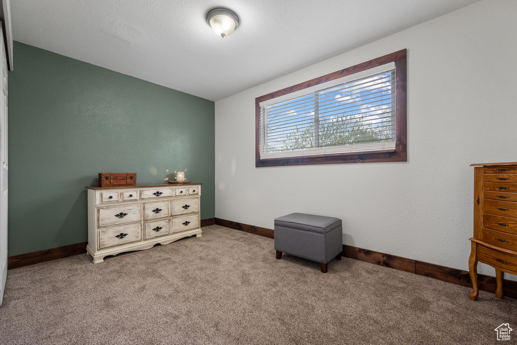 Bedroom featuring light carpet and baseboards