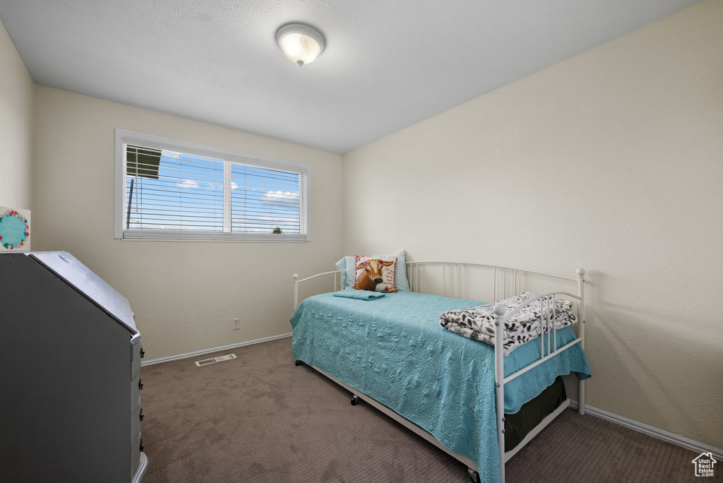 Bedroom with visible vents, baseboards, and carpet