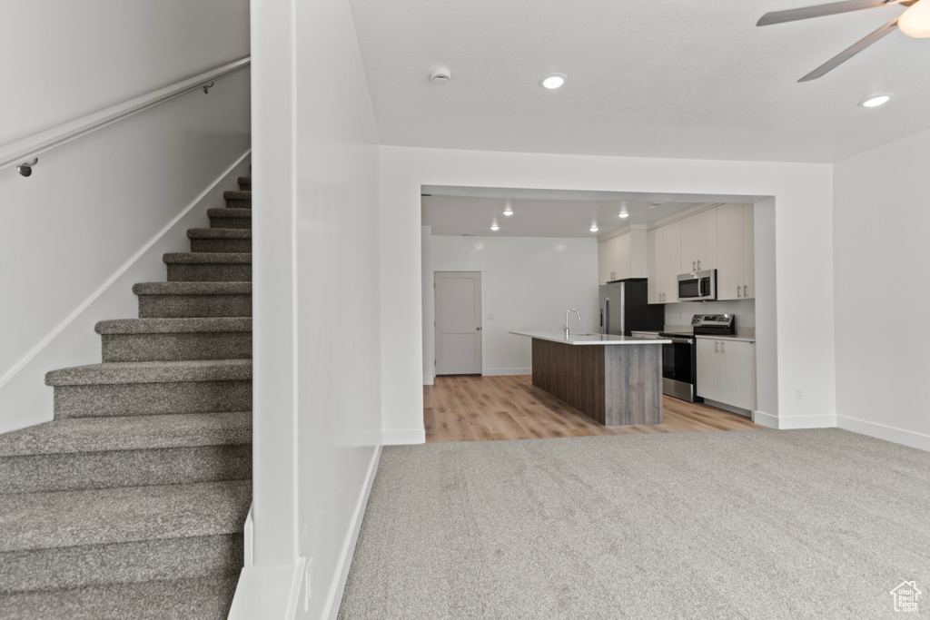 Interior space featuring recessed lighting, carpet, a ceiling fan, and baseboards
