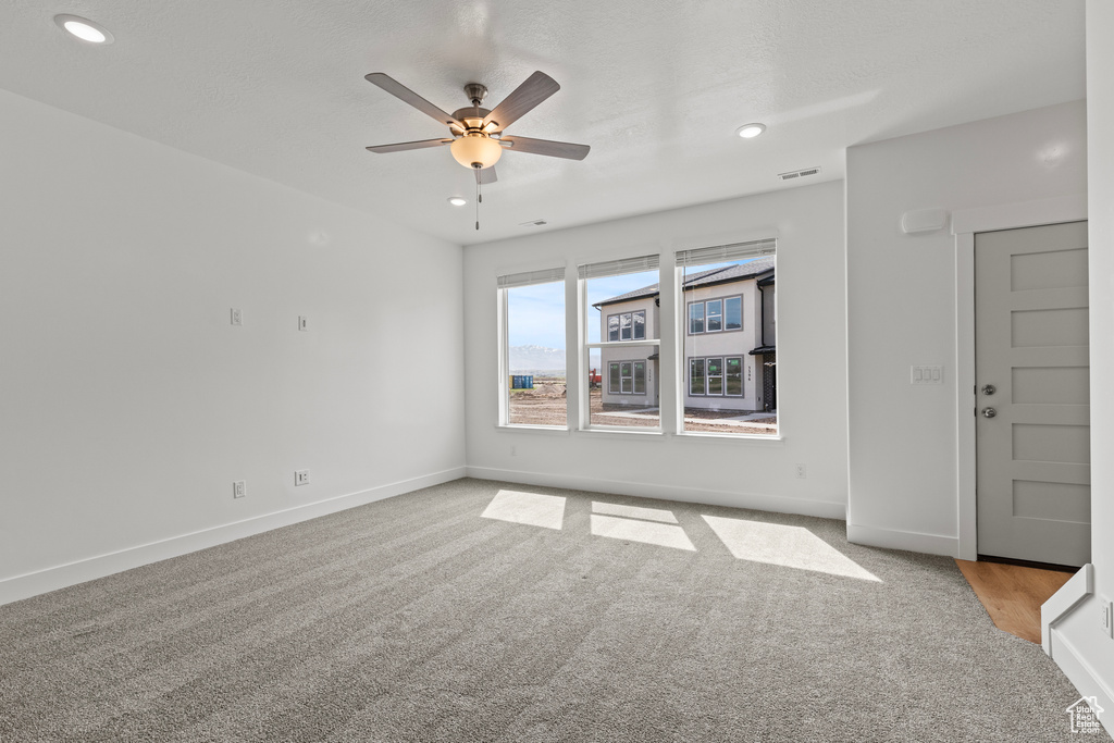Spare room with recessed lighting, carpet flooring, baseboards, and ceiling fan