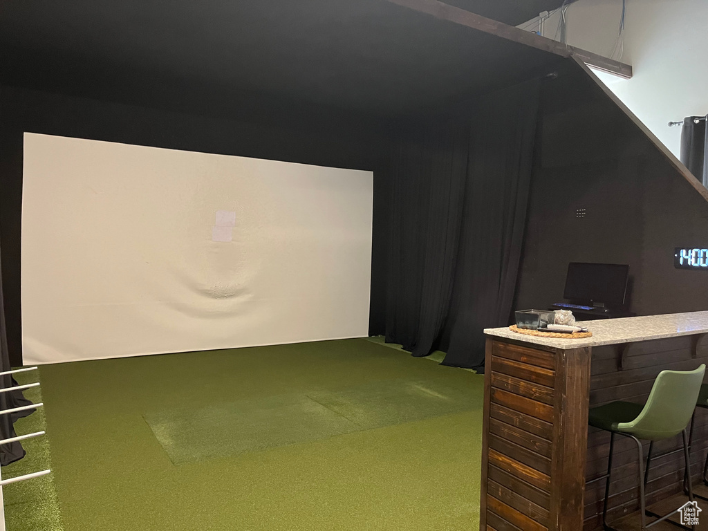 Game room featuring golf simulator and carpet floors