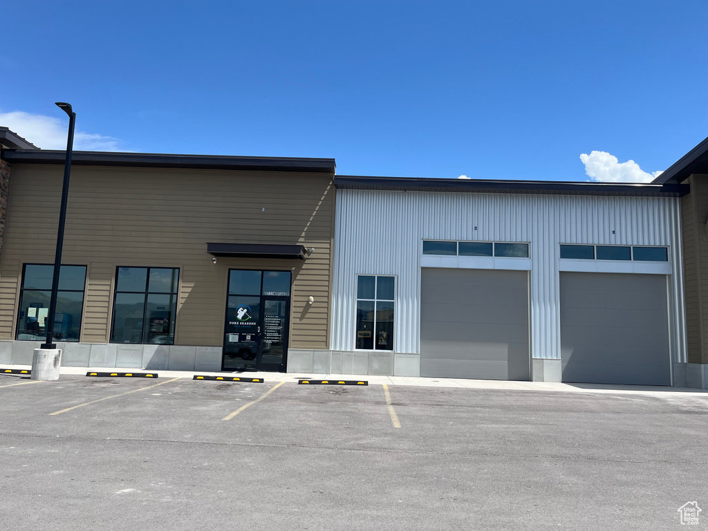 View of building exterior with uncovered parking