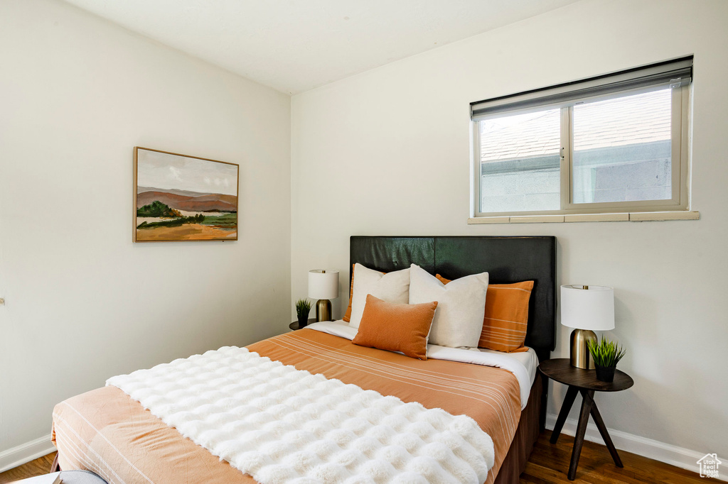 Bedroom featuring wood finished floors and baseboards