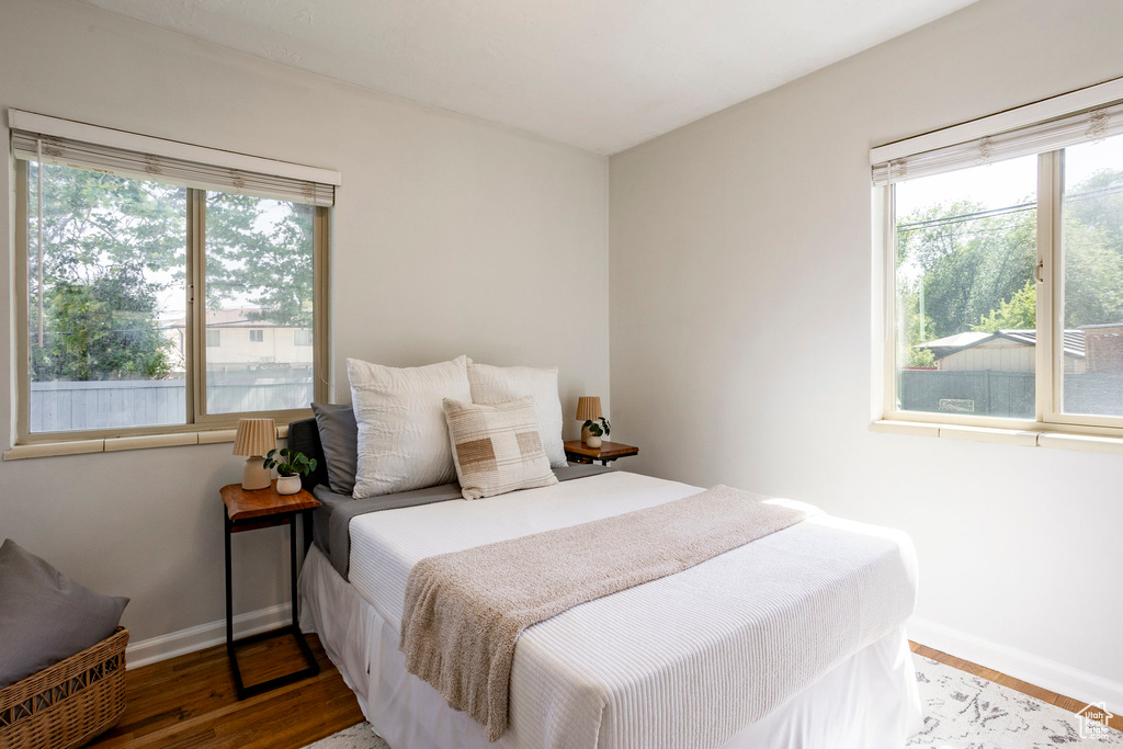 Bedroom with baseboards and wood finished floors