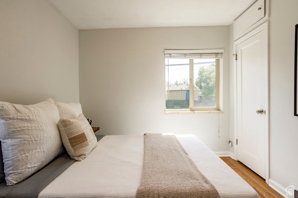 Bedroom with light wood-style flooring and baseboards