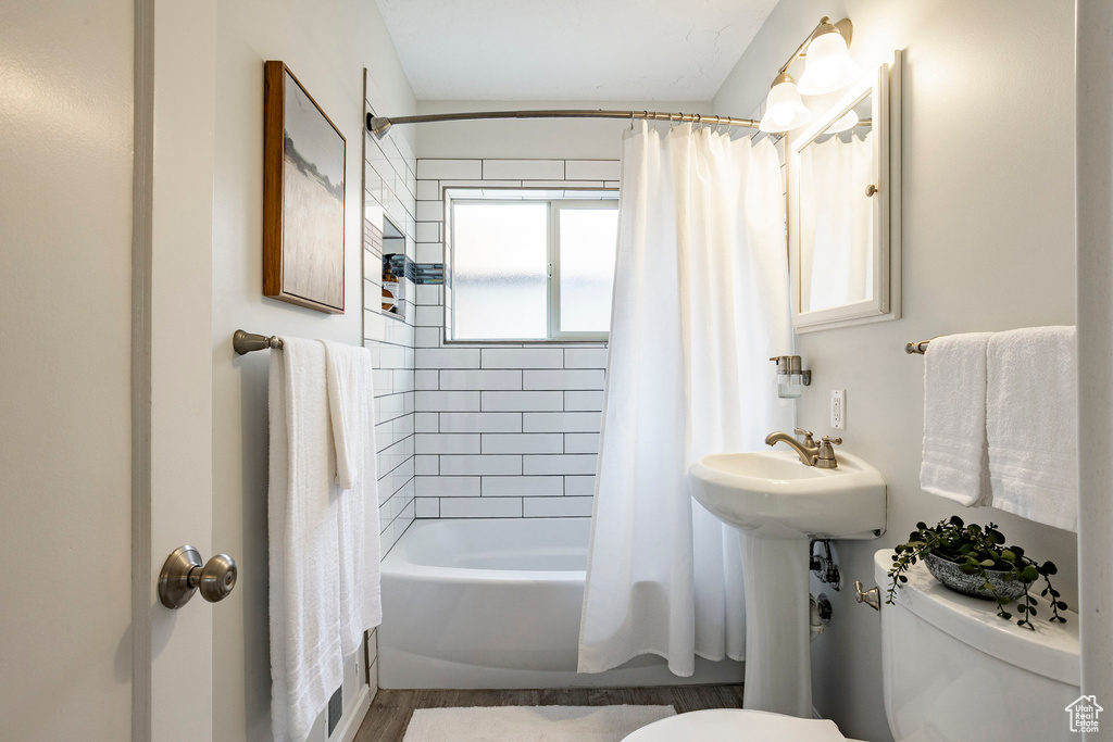 Full bathroom with toilet and shower / bath combo