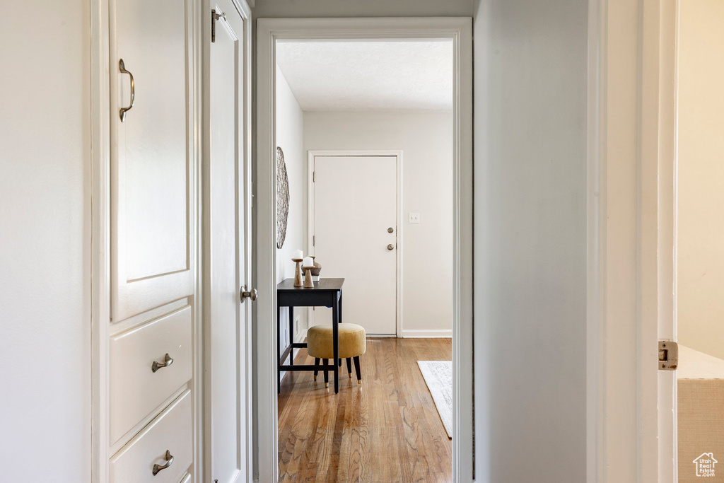 Hall featuring light wood finished floors