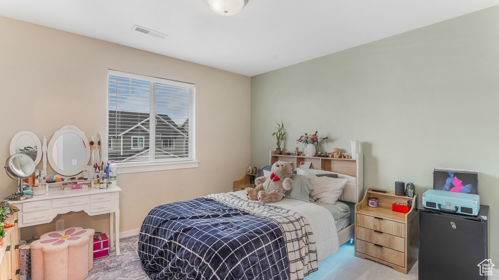 Carpeted bedroom with visible vents