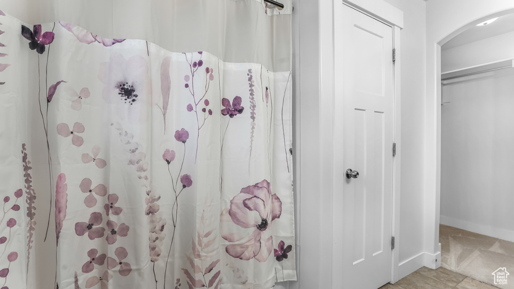 Full bathroom with baseboards and a shower with curtain