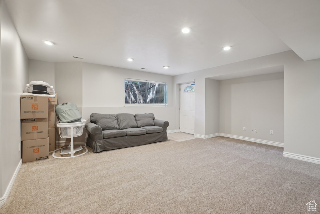 Carpeted living area with baseboards and recessed lighting
