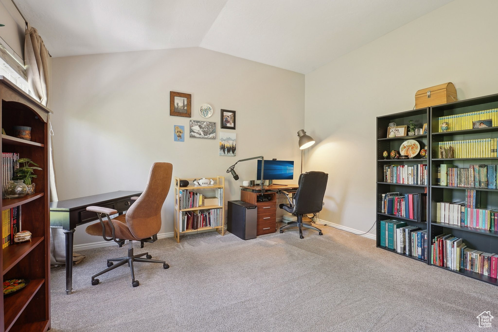 Carpeted office featuring baseboards and lofted ceiling