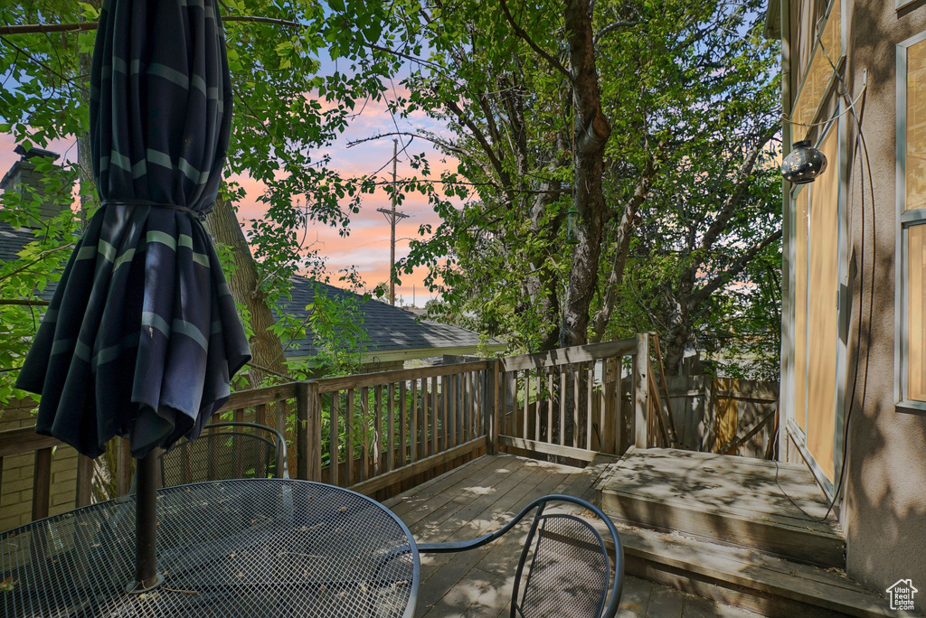Deck at dusk featuring outdoor dining space