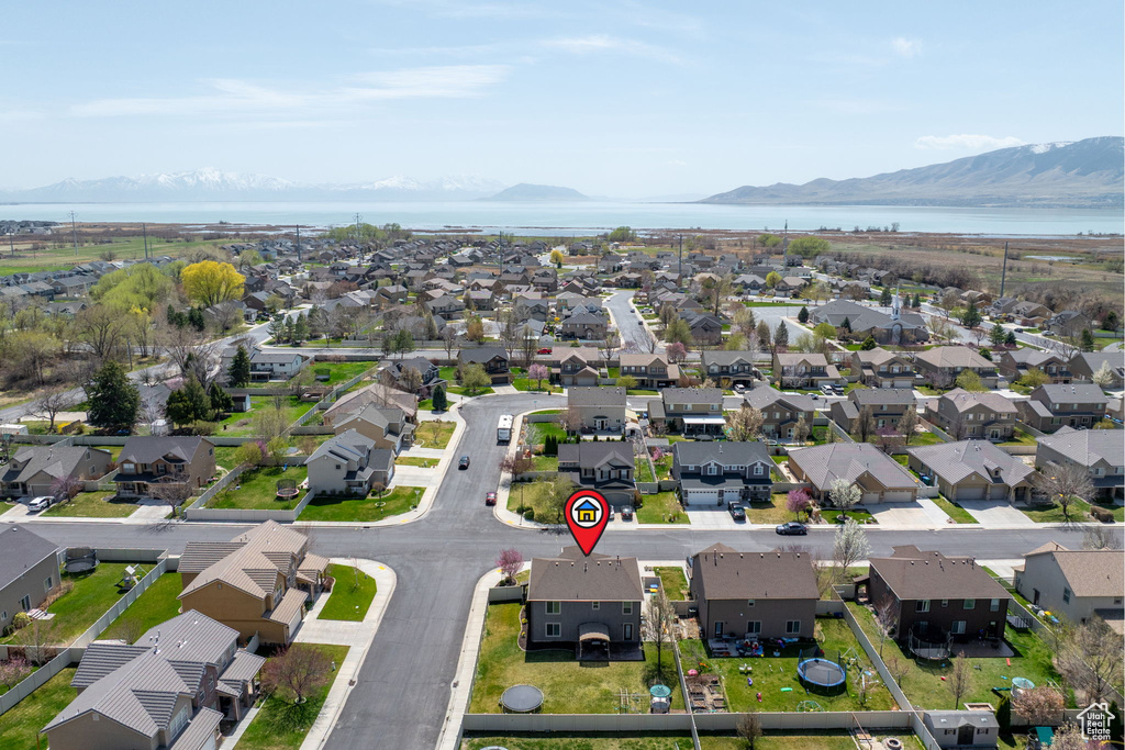 Birds eye view of property with a residential view and a water and mountain view