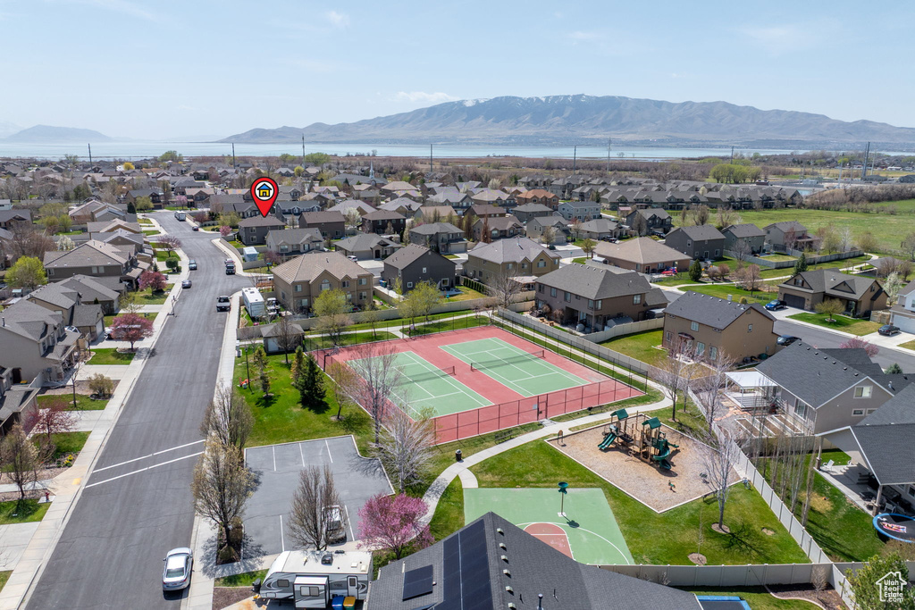 Birds eye view of property with a water and mountain view and a residential view
