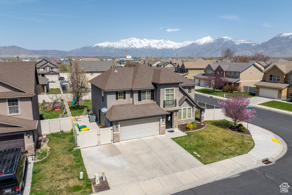View of front of house featuring a gate, driveway, stucco siding, roof with shingles, and a residential view