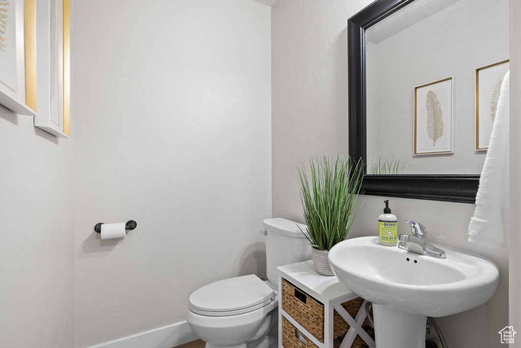 Half bathroom with toilet and a sink