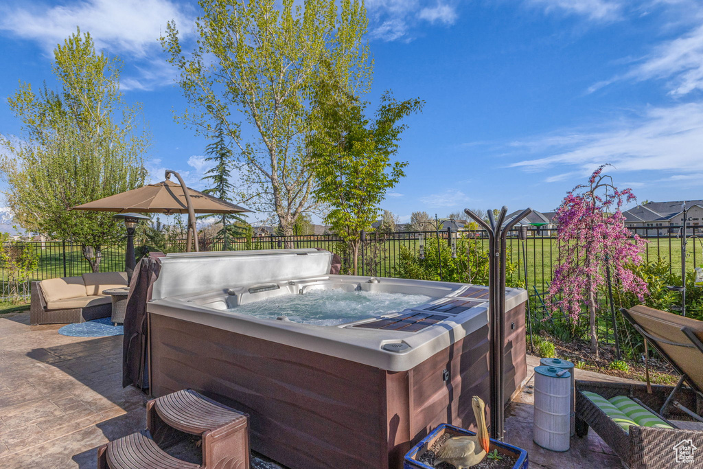View of patio with a hot tub